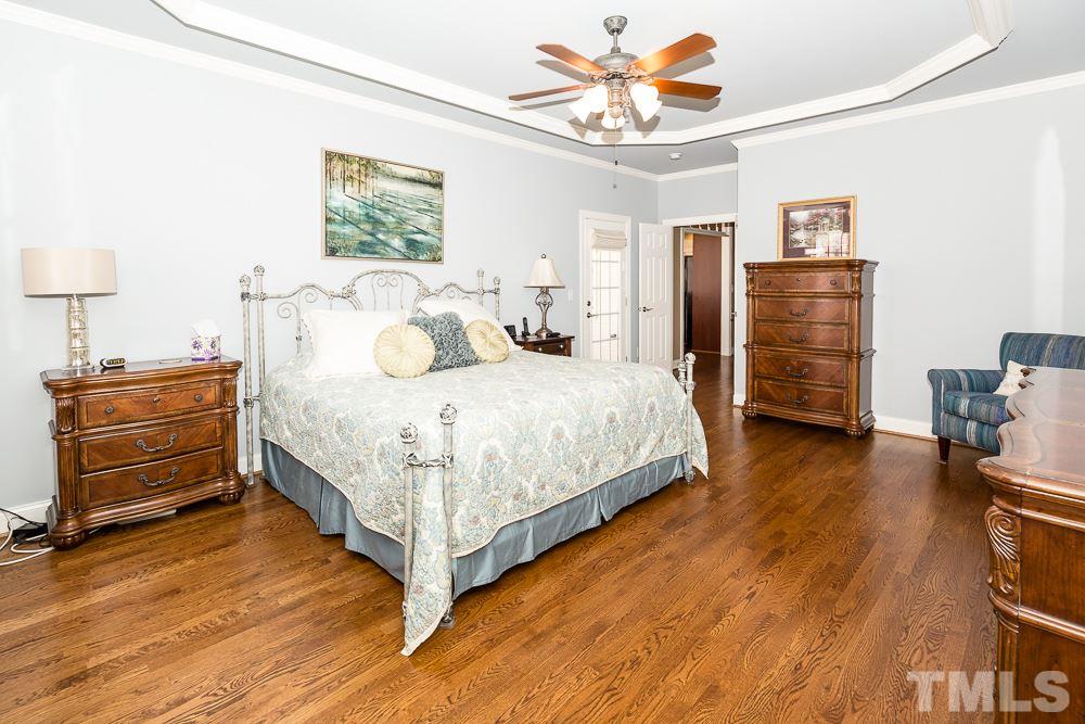 5109 Indigo Moon Way Raleigh, NC 27613 - Photo 12 of 24 a bedroom with a bed and wooden floor
