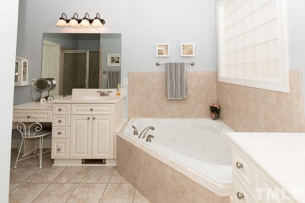 5109 Indigo Moon Way Raleigh, NC 27613 - Photo 14 of 24 a spacious bathroom with a sink and a bathtub