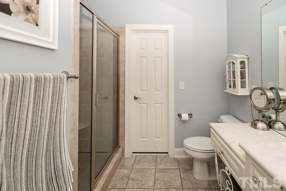 5109 Indigo Moon Way Raleigh, NC 27613 - Photo 15 of 24 a bathroom with a toilet a sink and shower