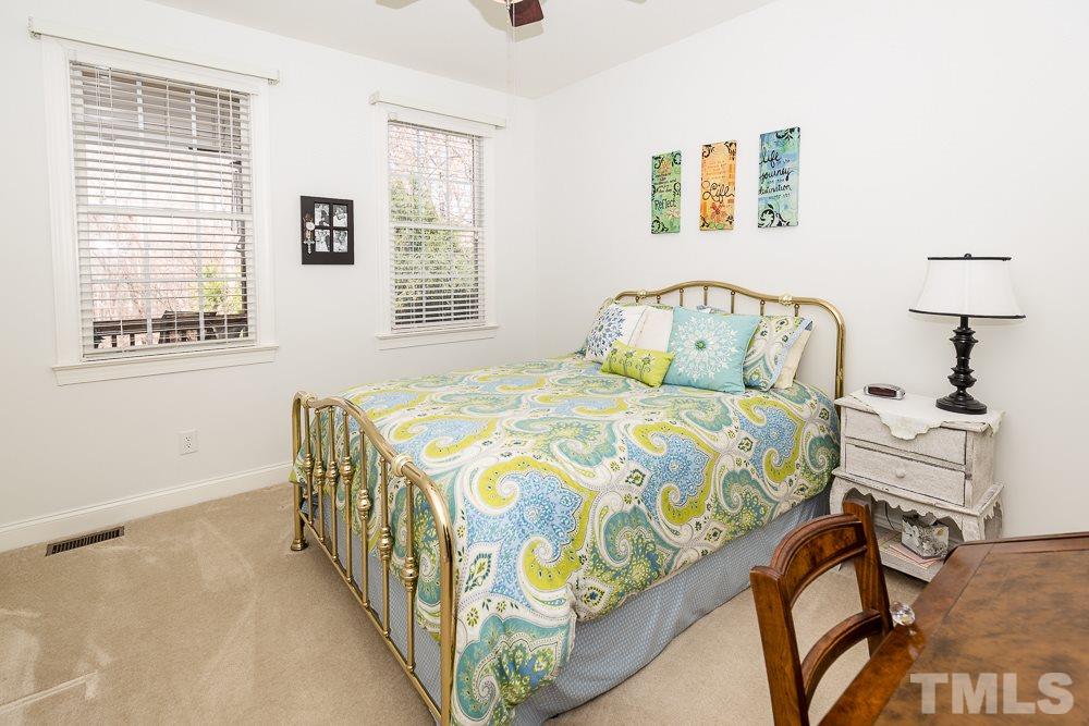5109 Indigo Moon Way Raleigh, NC 27613 - Photo 17 of 24 a bedroom with a bed and a table