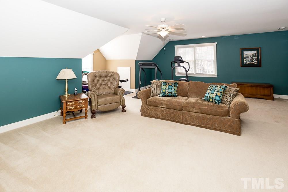 5109 Indigo Moon Way Raleigh, NC 27613 - Photo 18 of 24 a living room with furniture and a chandelier