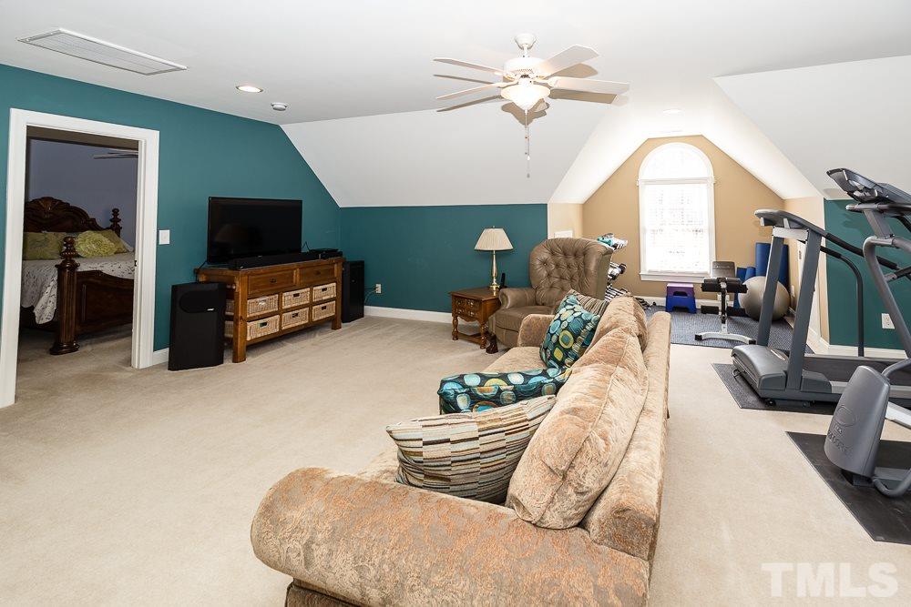 5109 Indigo Moon Way Raleigh, NC 27613 - Photo 19 of 24 a living room with furniture fireplace and a flat screen tv