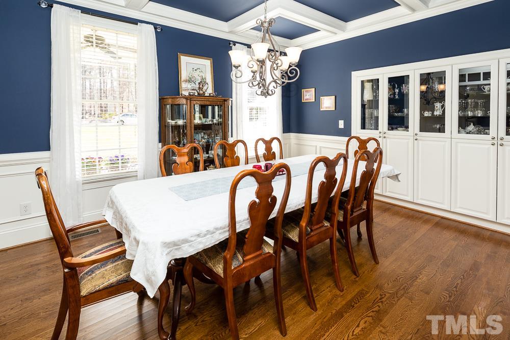 5109 Indigo Moon Way Raleigh, NC 27613 - Photo 3 of 24 a view of a dining room with furniture wooden floor and chandelier