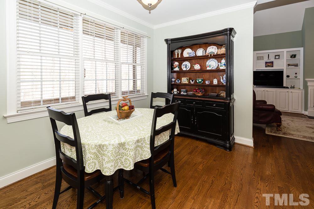 5109 Indigo Moon Way Raleigh, NC 27613 - Photo 10 of 24 a view of a dining room with furniture and wooden floor