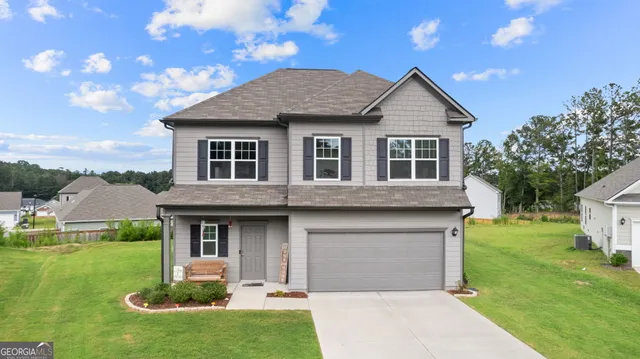 a front view of a house with a yard