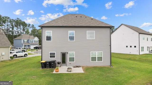 a front view of house with yard having outdoor seating