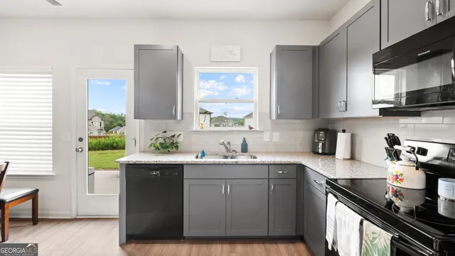 a kitchen with a sink cabinets and window