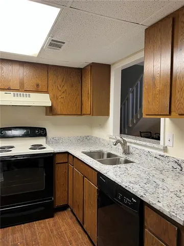 a kitchen with a sink stove and cabinets