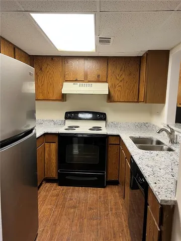a kitchen with granite countertop a stove and a sink