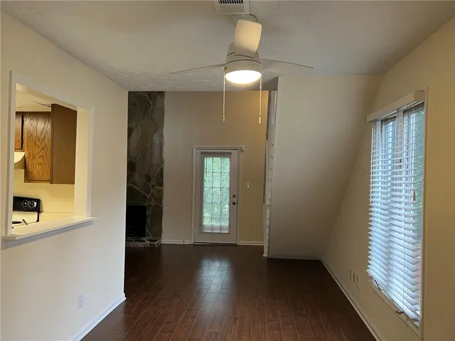 wooden floor in an empty room with a window