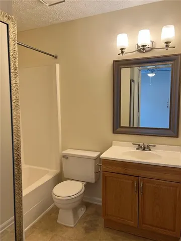 a bathroom with a toilet a sink and a mirror