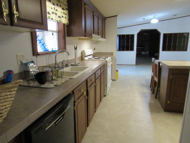 7450 Old River Road Baker, FL 32531 - Photo 2 of 26 a kitchen with stainless steel appliances granite countertop a sink a stove and a refrigerator
