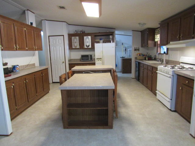 7450 Old River Road Baker, FL 32531 - Photo 3 of 26 a kitchen with stainless steel appliances a stove sink refrigerator and cabinets