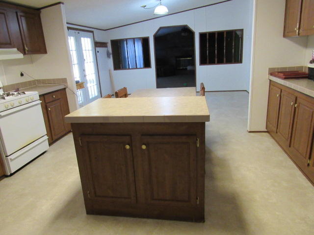 7450 Old River Road Baker, FL 32531 - Photo 4 of 26 a kitchen with a sink and wooden cabinets