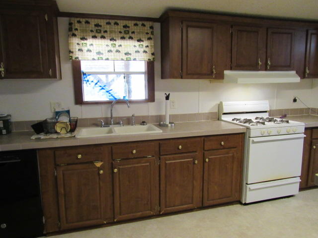 7450 Old River Road Baker, FL 32531 - Photo 6 of 26 a kitchen with a sink window and cabinets