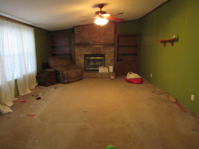 7450 Old River Road Baker, FL 32531 - Photo 8 of 26 a living room with furniture and a fireplace
