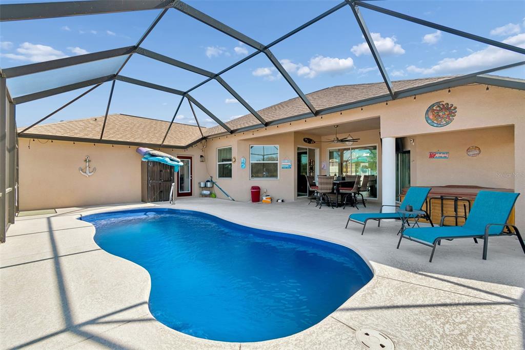 18317 Treehaven Drive Hudson, FL 34667 - Photo 48 of 60 a view of a swimming pool with a patio