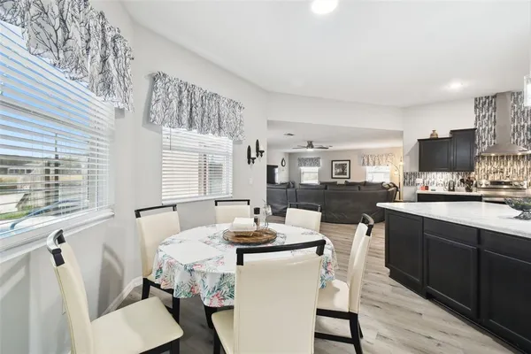 a living room with stainless steel appliances kitchen island granite countertop furniture wooden floor and a view of kitchen