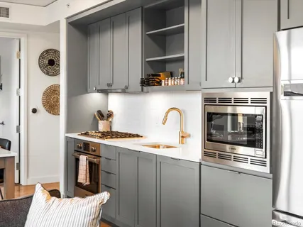 a kitchen with stainless steel appliances granite countertop a stove a sink and a refrigerator