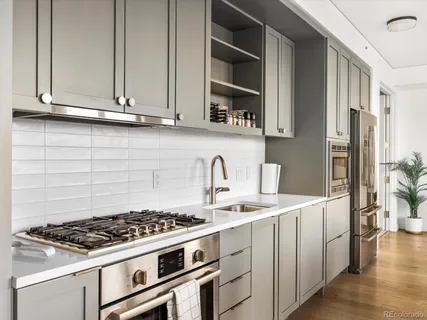 a kitchen with stainless steel appliances granite countertop a stove and a refrigerator