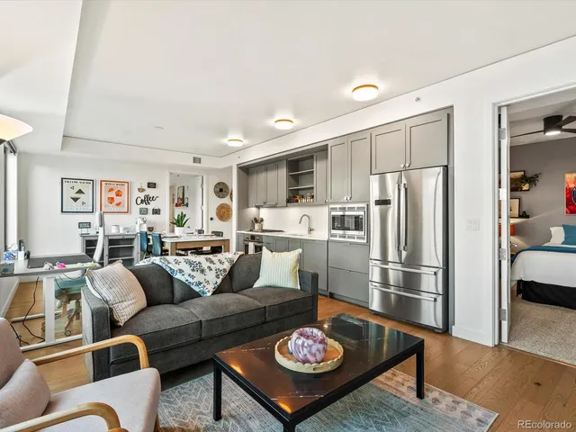 a living room with furniture kitchen and a table