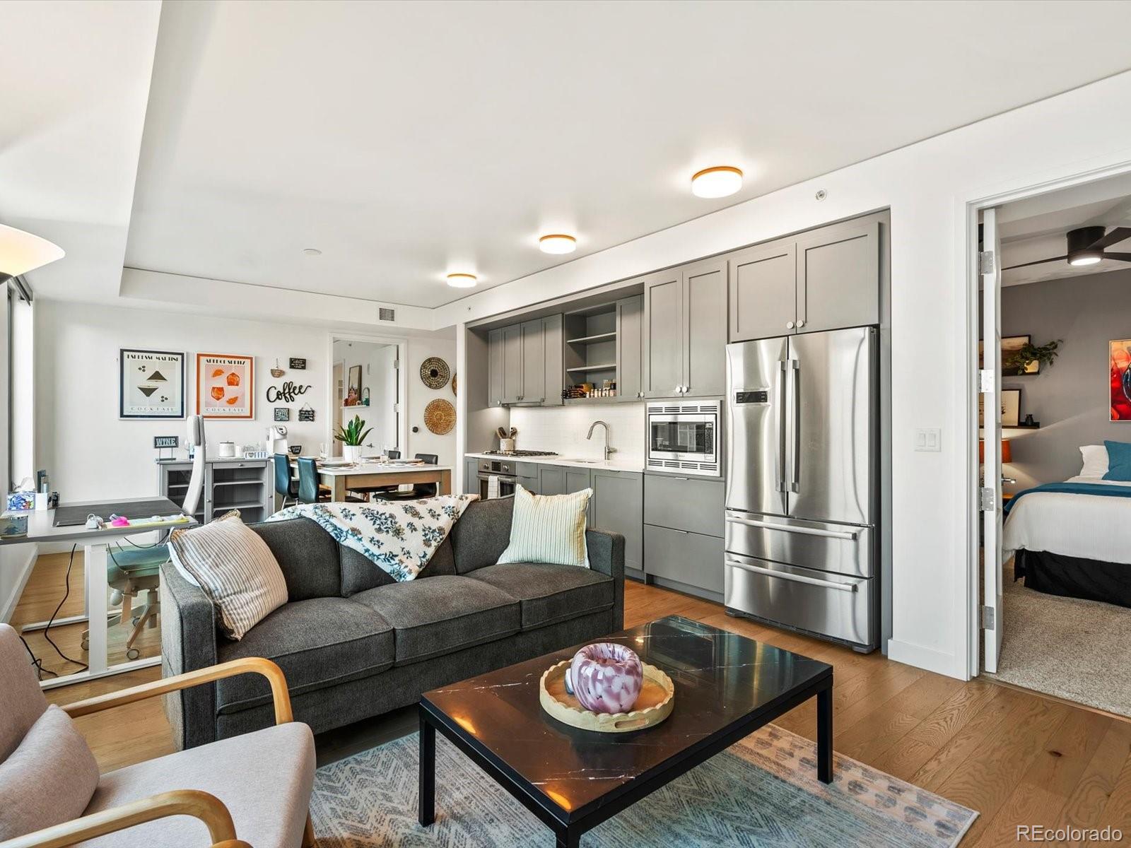 1750 Wewatta Street, Unit 1409 Denver, CO 80202 - Photo 16 of 48 a living room with furniture kitchen and a table