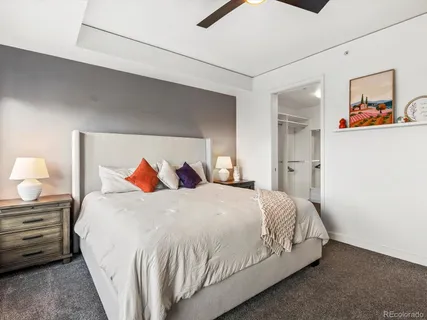 a bedroom with a bed and wall painting