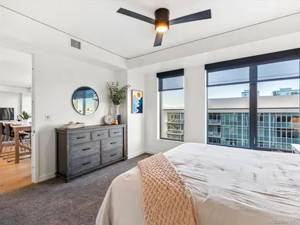 a spacious bedroom with a large bed and a dresser