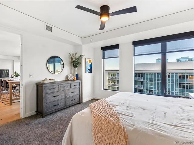 a spacious bedroom with a large bed and a dresser