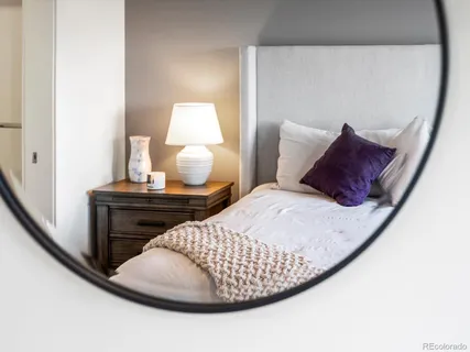 a bedroom with a bed and a night stand