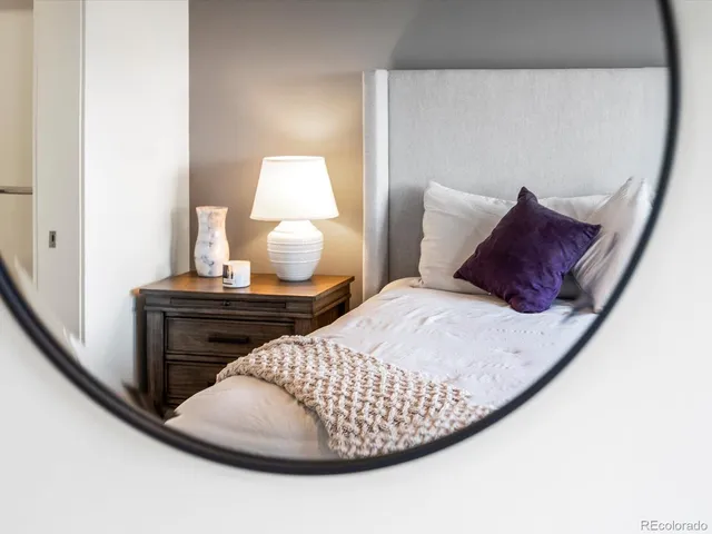 a bedroom with a bed and a night stand