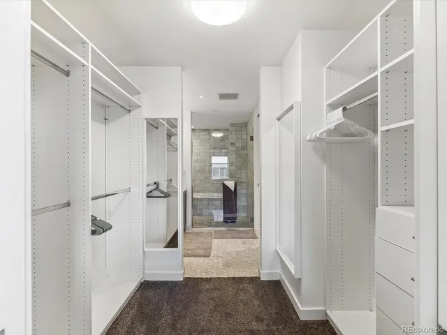 a view of a hallway with wooden shelves