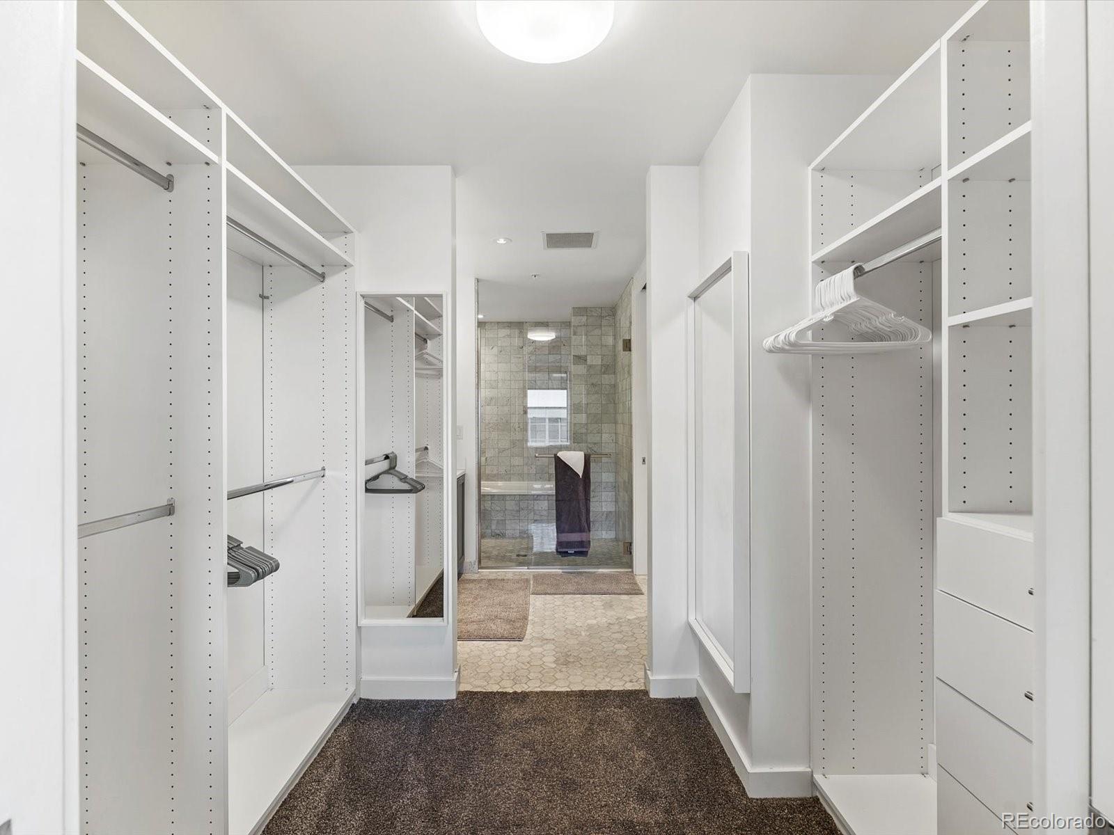 1750 Wewatta Street, Unit 1409 Denver, CO 80202 - Photo 20 of 48 a view of a hallway with wooden shelves