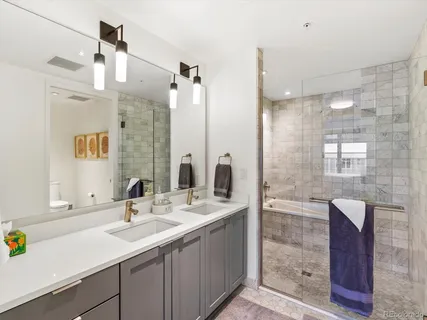 a bathroom with a sink double vanity and a shower