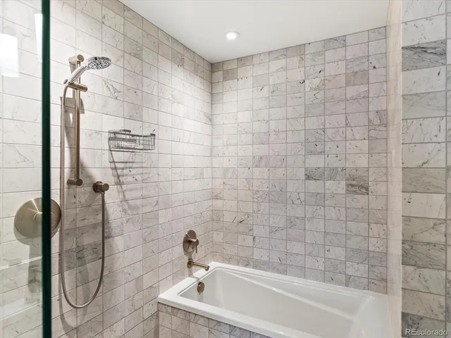 a bathroom with a bathtub and shower