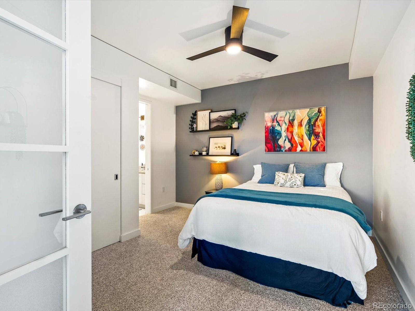 1750 Wewatta Street, Unit 1409 Denver, CO 80202 - Photo 24 of 48 a bedroom with a bed and a painting on the wall