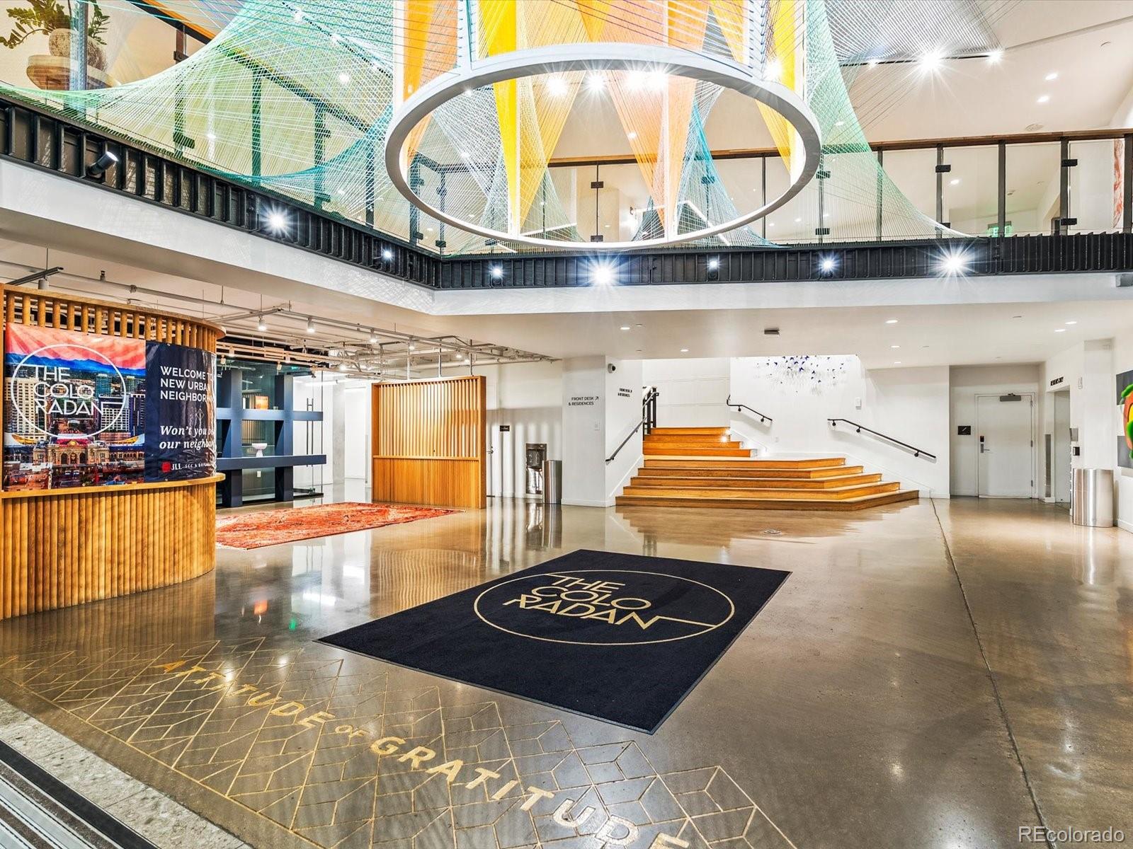 1750 Wewatta Street, Unit 1409 Denver, CO 80202 - Photo 28 of 48 a room with lots of white furniture and a rug