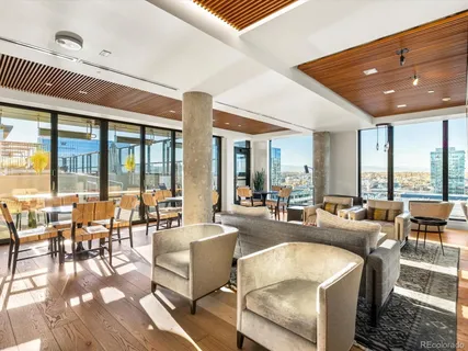 a living room with furniture and large windows