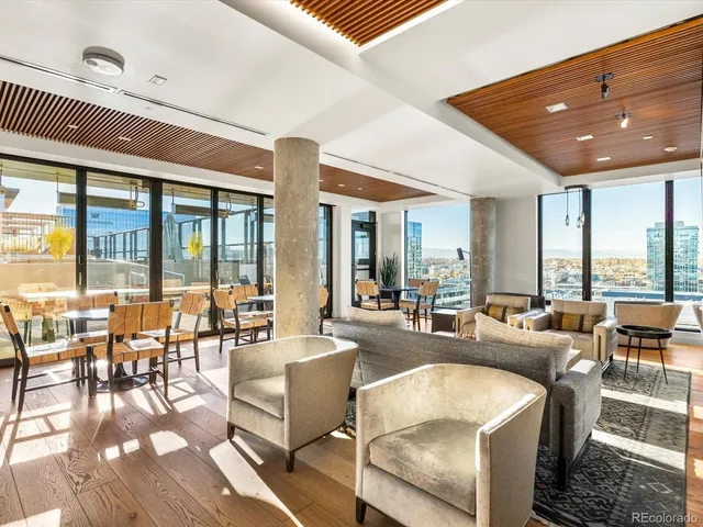 a living room with furniture and large windows