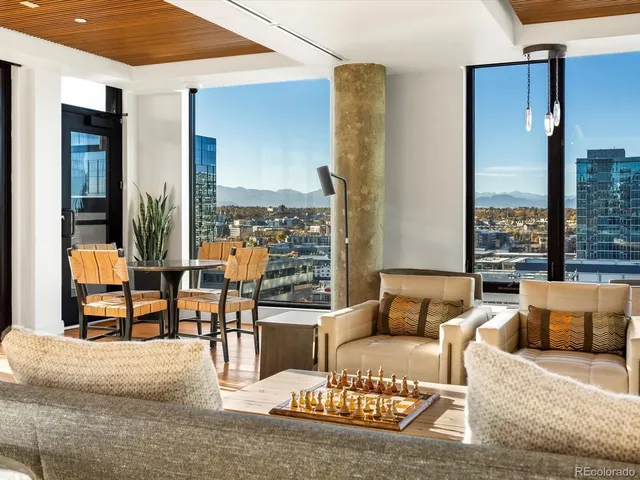 a living room with furniture and a floor to ceiling window