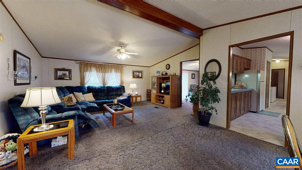 1728 Ridge Road Raphine, VA 24472 - Photo 3 of 34 a living room with furniture a chandelier and a flat screen tv