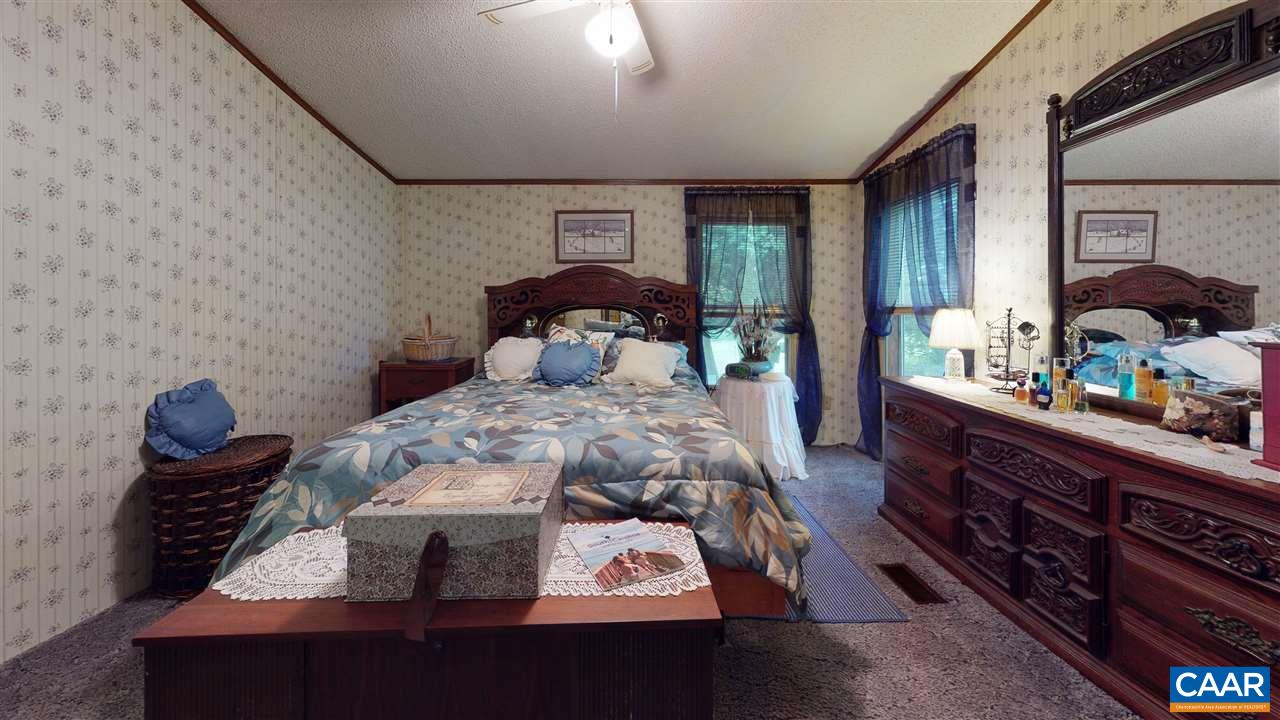 1728 Ridge Road Raphine, VA 24472 - Photo 8 of 34 a bed sitting in a bedroom next to a window