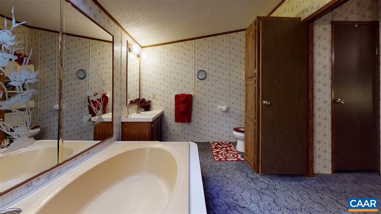 1728 Ridge Road Raphine, VA 24472 - Photo 10 of 34 a bathroom with a tub shower sink and mirror