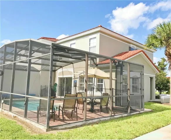 a backyard of a house with table and chairs