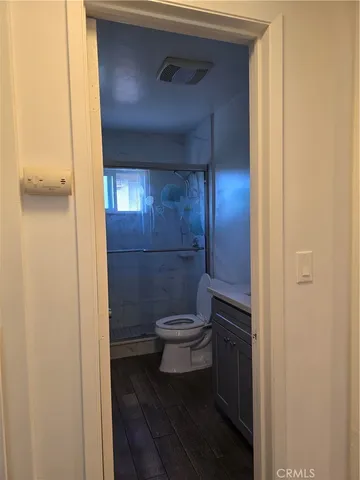a bathroom with a toilet and a shower