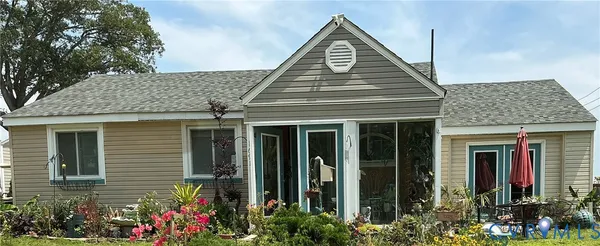 a view of a house with potted plants