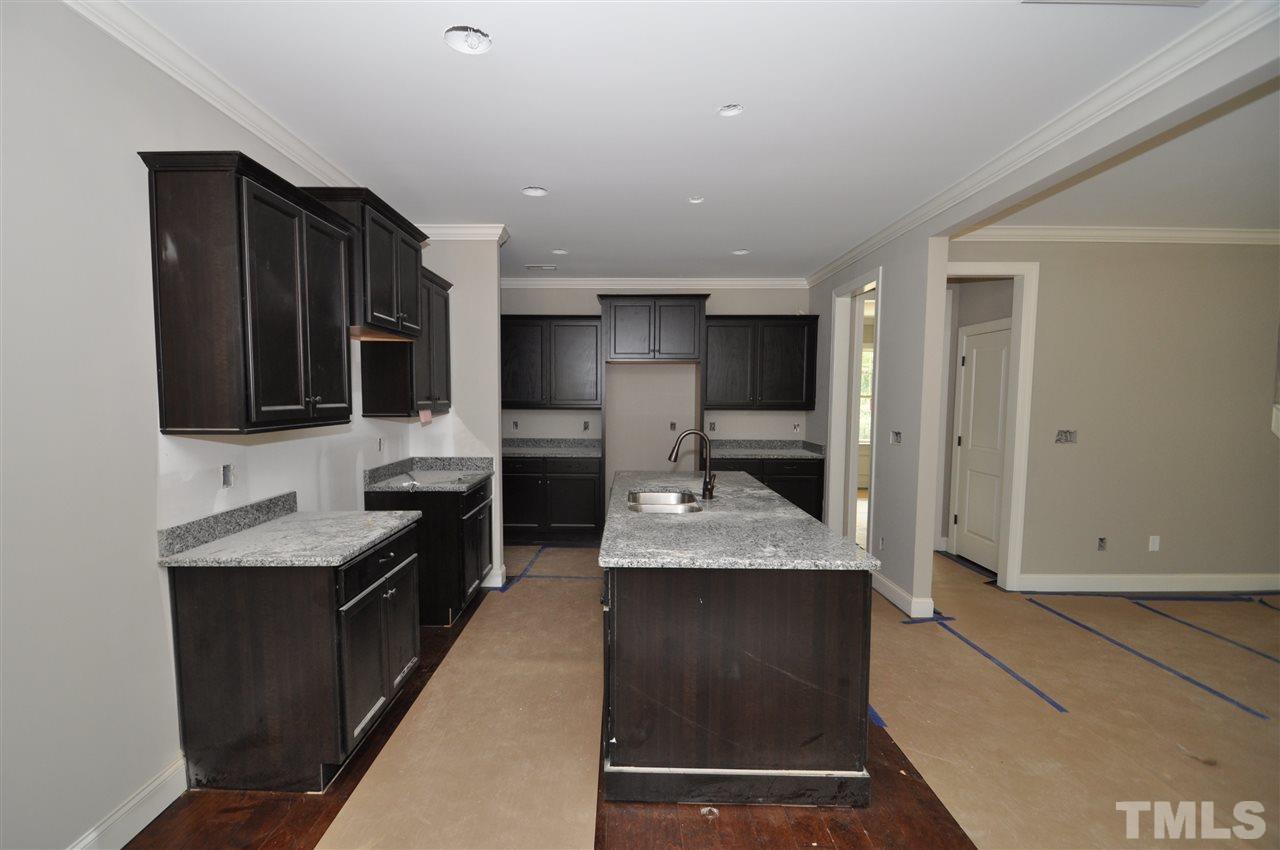 2025 Sageleaf Court Raleigh, NC 27603 - Photo 6 of 14 a kitchen with stainless steel appliances granite countertop a sink stove and oven