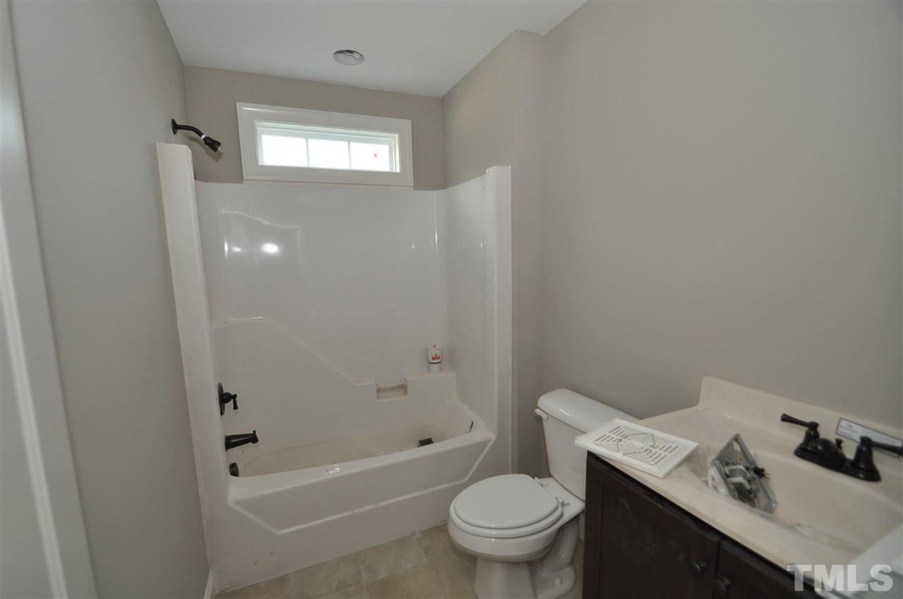 2025 Sageleaf Court Raleigh, NC 27603 - Photo 8 of 14 a bathroom with a sink toilet and shower
