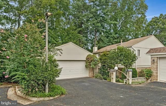 a view of a house with a yard and potted plants