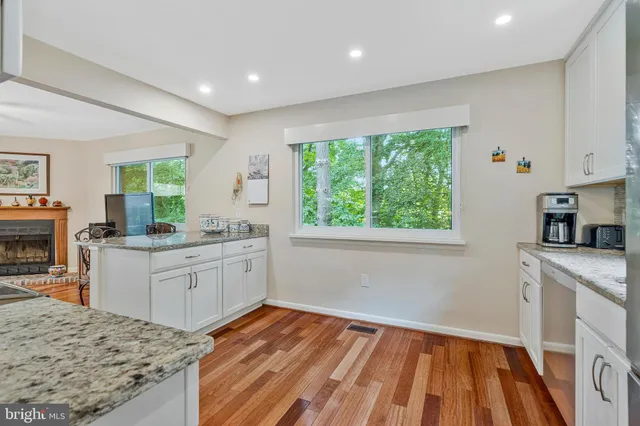 a kitchen with stainless steel appliances granite countertop a sink and a refrigerator